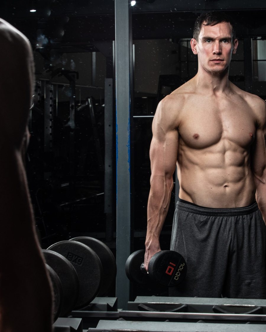 Rob in the gym holding dumbbells