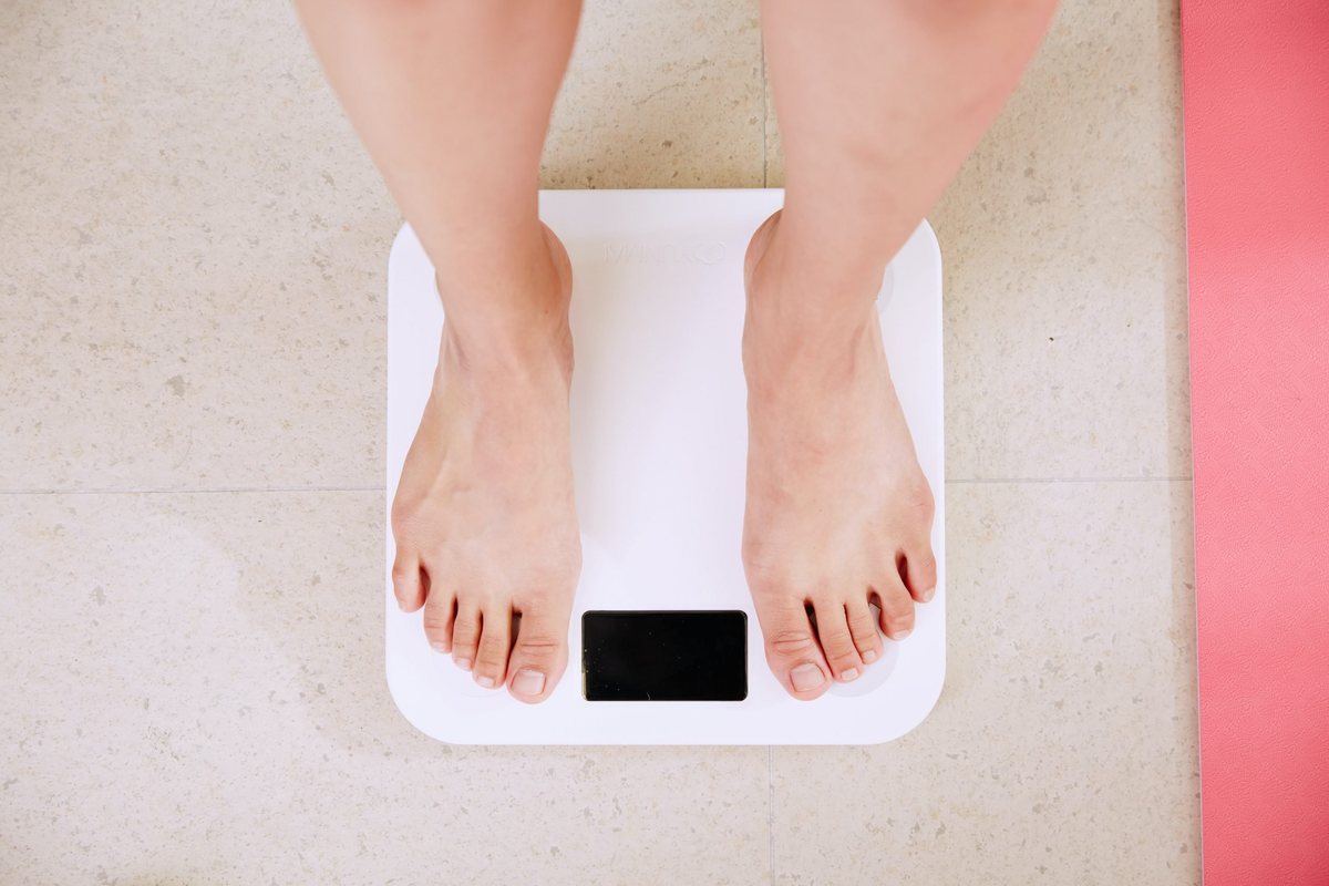 A man standing on bathroom scales