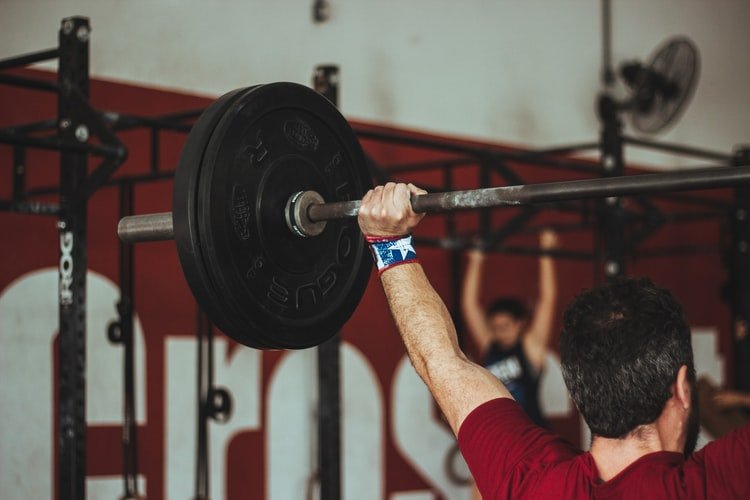 man performing overhead press