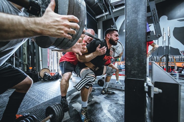 squatting heavy with spotters